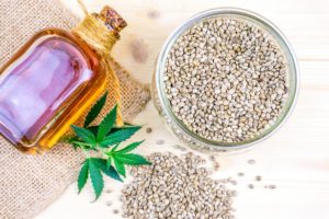 cannabis-seeds-in-glass-bowl-on-table-and-hemp-clo-2023-11-27-04-56-44-utc